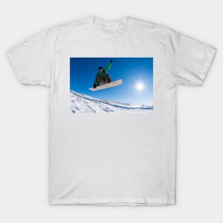 Snowboarder jumping against blue sky T-Shirt